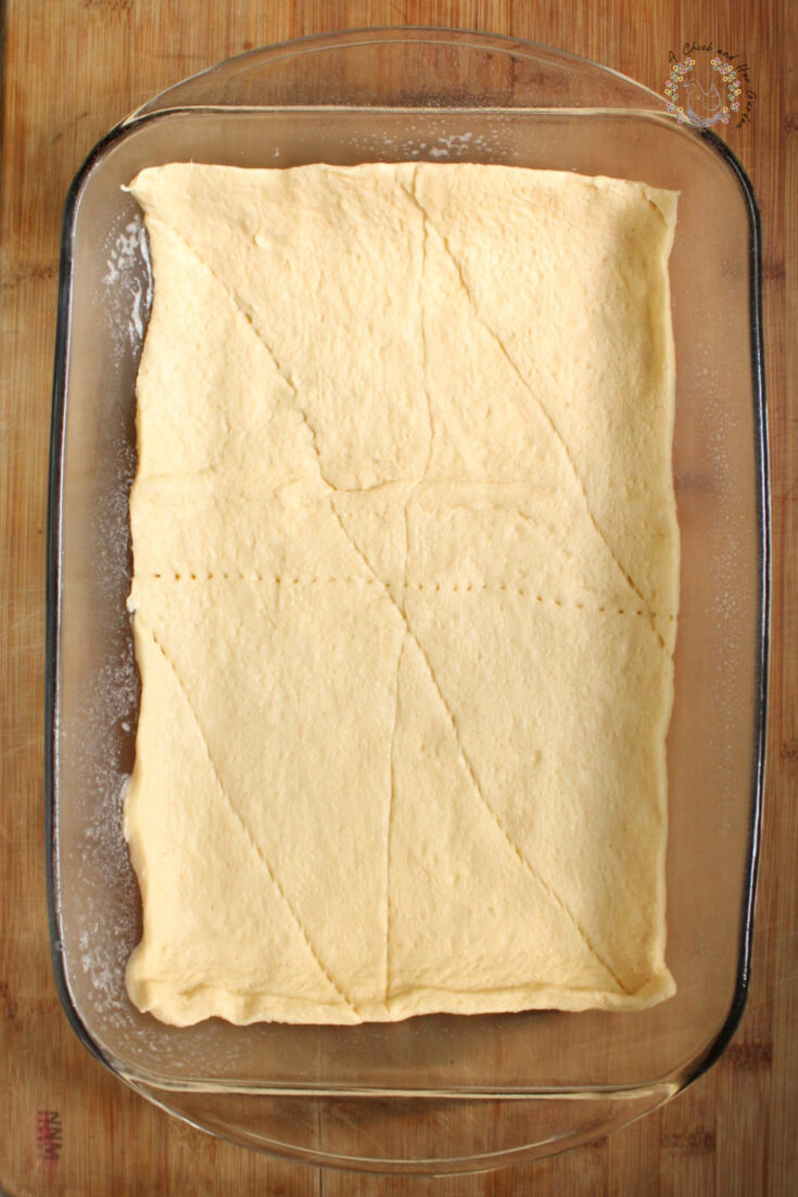 crescent roll dough rolled out in a glass 9x13 pan