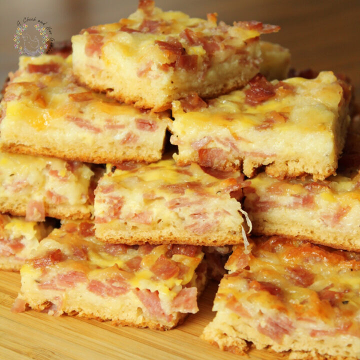 salami square snacks stacked on a bamboo cutting board