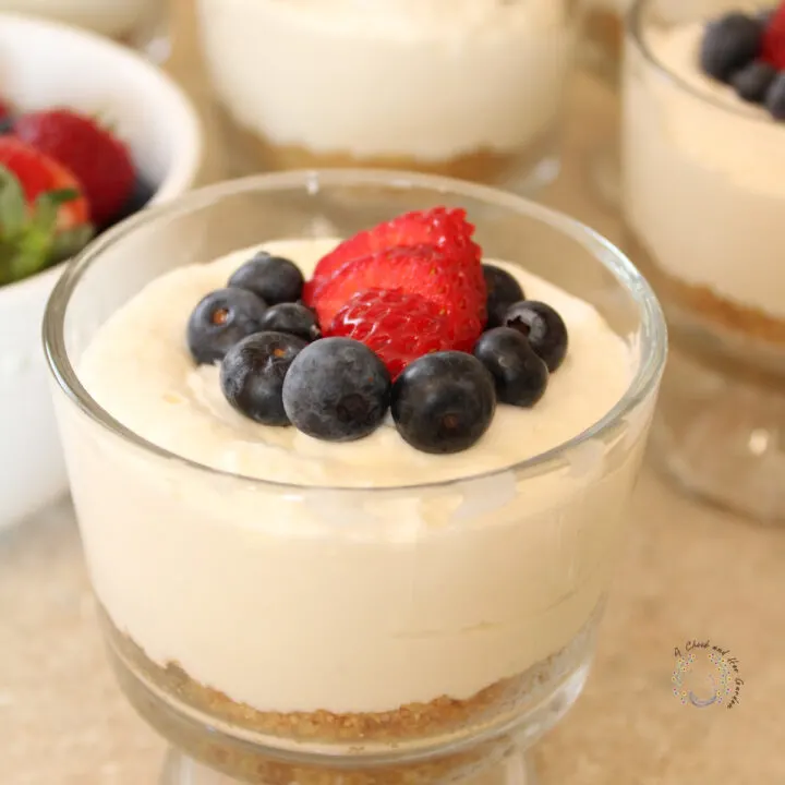 no bake cheesecake in a mini trifle bowl with fresh berries on top