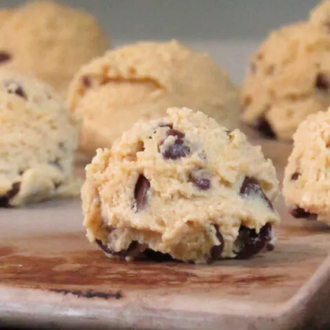 chocolate chip cookie dough balls on a stone cookie sheet