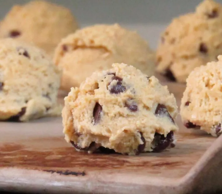 chocolate chip cookie dough balls on a stone cookie sheet