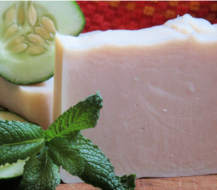 white soap with a sprig of mint and a slice of cucumber