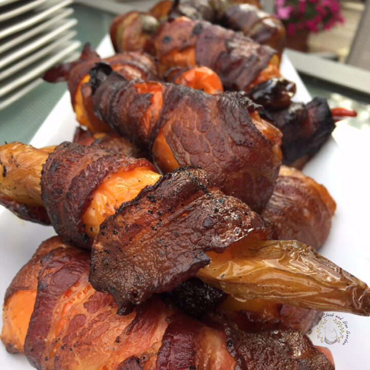 plate of mini stuffed sweet peppers wrapped in bacon and smoked