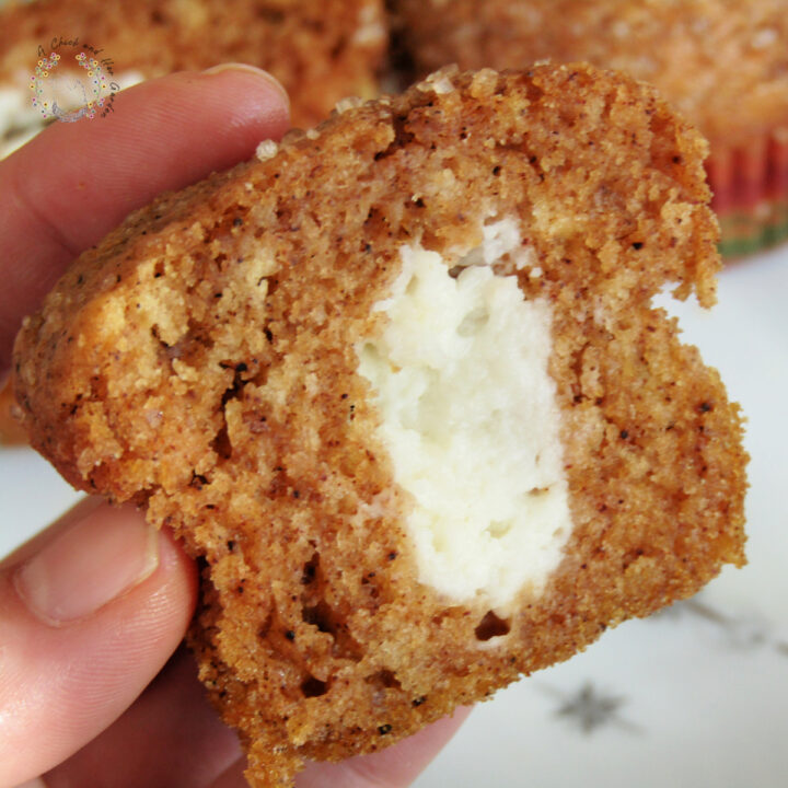 pumpkin roll muffin cut in half, showing the cream filling center