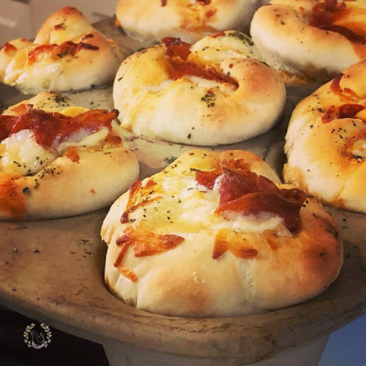 closeup of sourdough pizza rolls in a stone muffin pan