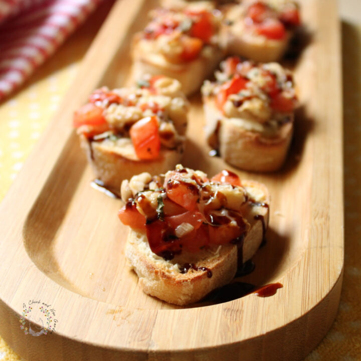 closeup of bruschetta crostini slices on a bamboo tray