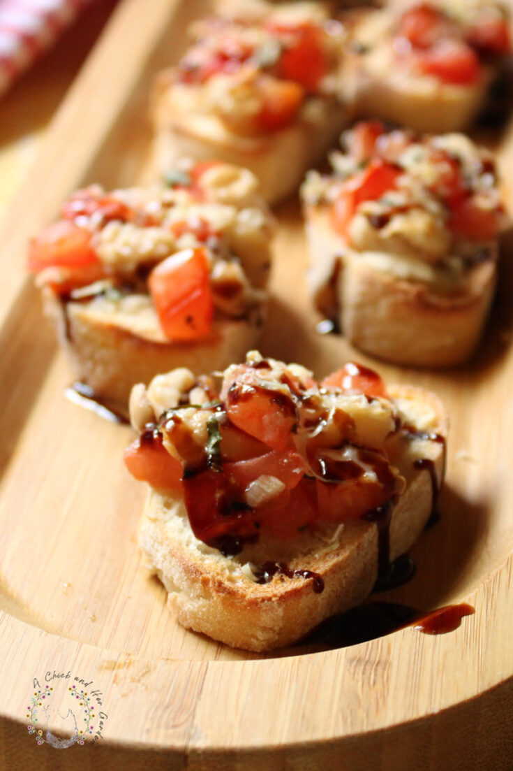 closeup of bruschetta crostini slices on a bamboo tray